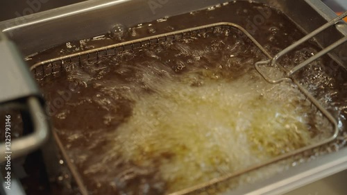 Сhicken tights frying in oil close up. Fast food cooking