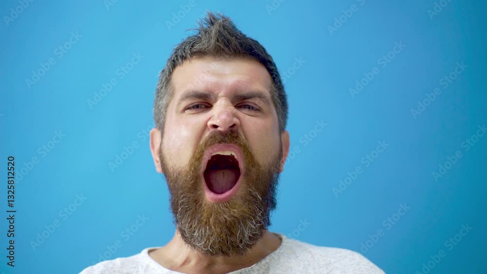 Man expressing his feelings and facial expressions. Man Facial Emotions. Male Character, Furrow Brows, Angry, Shocked Expression. Studio close up portrait of bearded man confused facial expression.