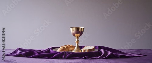 Holy Communion Chalice and Bread on Purple Cloth. photo