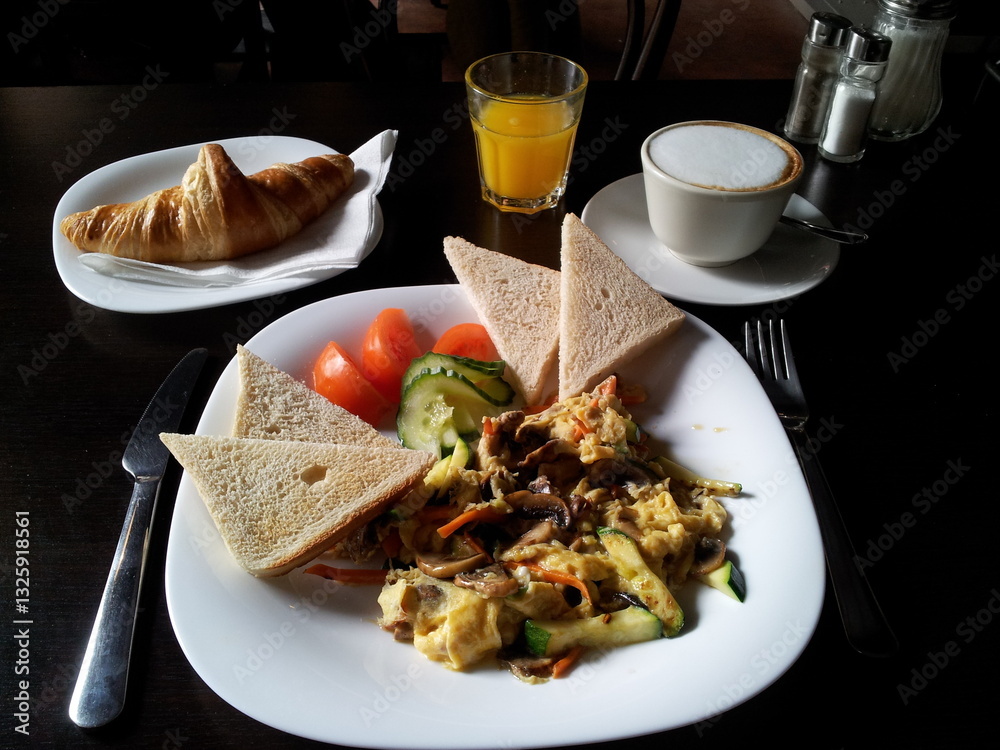 Breakfast & Brunch with vegetabes, toast, croissont, coffee and fresh orange juice.