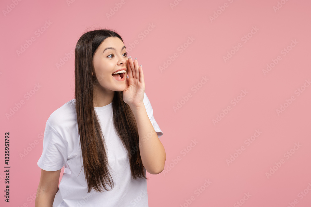 Happy, attractive teen girl sharing secret on pink background Happy, attractive teen girl sharing secret on pink background