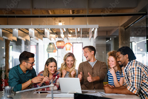 Obraz na płótnie Group portrait of young startup business team celebrating success in the office w salonie
