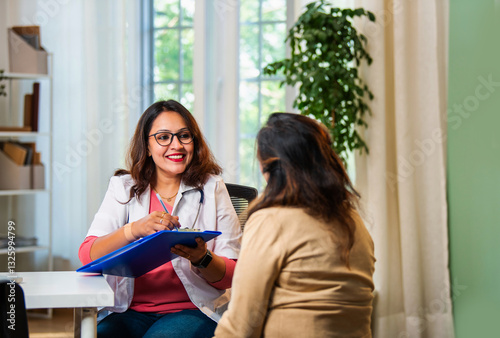 Slika na platnu Indian Young female doctor discussing medical case report with senior patient in