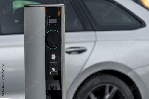 Fototapeta Naklejka Na Ścianę i Meble -  Electric car charging station in a parking, empty parking space with an electric car charger,