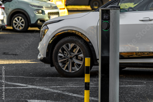 Fototapeta Naklejka Na Ścianę i Meble -  Electric car charging station in a parking, empty parking space with an electric car charger,