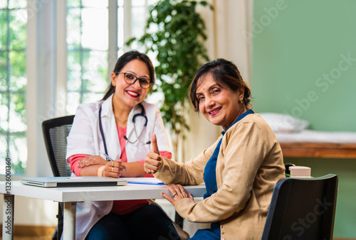 Indian doctor and elderly patient share a warm handshake, celebrating healthcare and recovery