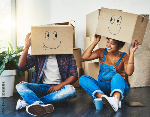 Emoji, boxes and couple on floor in new home for property, residential purchase and moving day. Homeowner, real estate and man and woman with funny face for relocation, packing and rental apartment