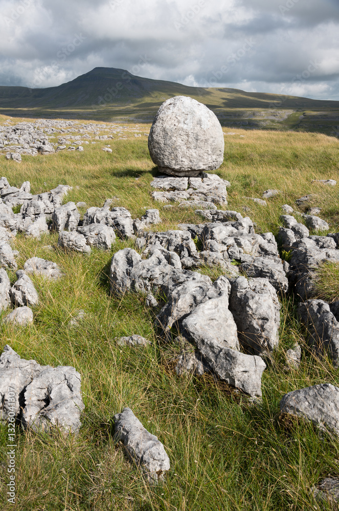 Erratic bolder and limestone pavement on Twisleton Scar, Scales Moor, looking towards Ingleborough, near Ingleton, Yorkshire Dales National Park, England Erratic bolder and limestone pavement on Twisleton Scar, Scales Moor, looking towards Ingleborough, near Ingleton, Yorkshire Dales National Park, England