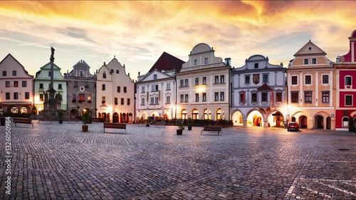 Time lapse - Scenery of the Plaza in Cesky Krumlov, a medieval town in Czech Republic with colorful houses, monument in the square  before sunrise. Czech republic