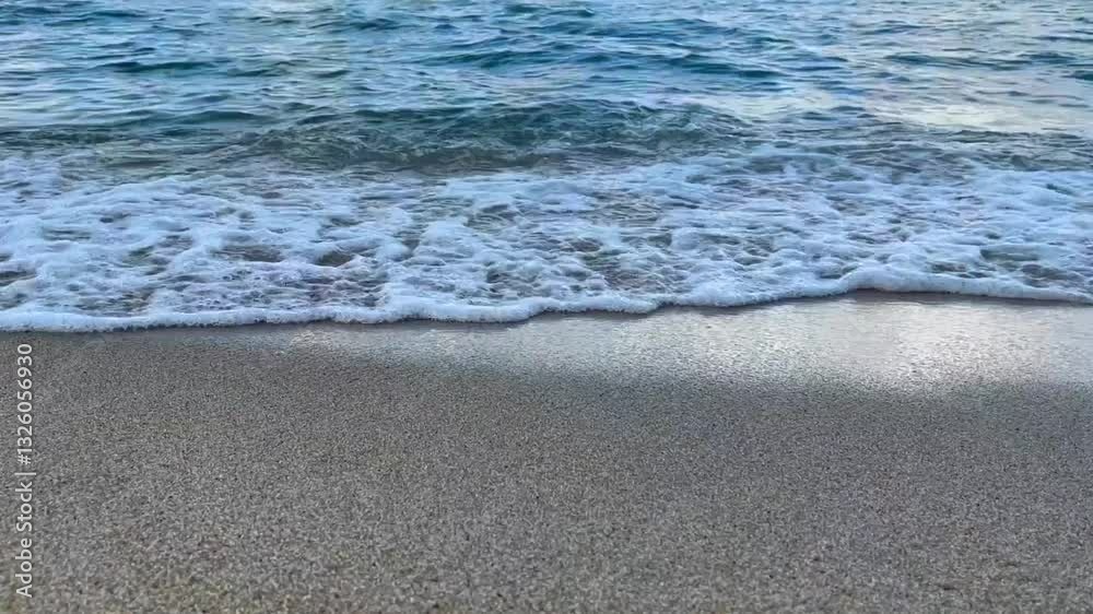 Gentle ocean water washing over a sandy shore, creating a peaceful and calming atmosphere. The rhythmic movement of the tide enhances the sense of relaxation, meditation, nature themed content Gentle ocean water washing over a sandy shore, creating a peaceful and calming atmosphere. The rhythmic movement of the tide enhances the sense of relaxation, meditation, nature themed content