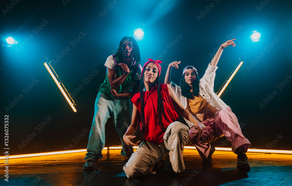 Fototapeta premium Group of hip hop dancer dancing together in a moody studio with tube neon lights.