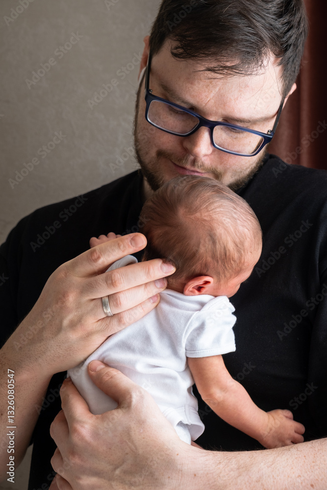 Man Holding Newborn Baby in Tender Moment
