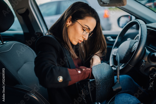 Wallpaper Mural Businesswoman searching inside her handbag while sitting in car Torontodigital.ca