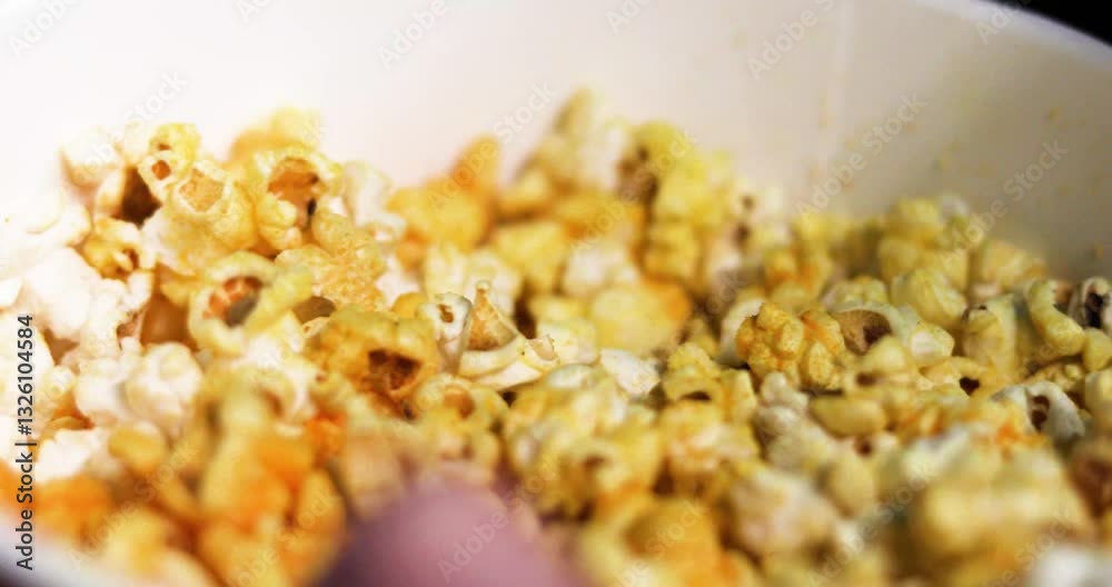 eating cheese popcorn while watching a movie in a cinema. Experience and emotions. eating cheese popcorn while watching a movie in a cinema. Experience and emotions.