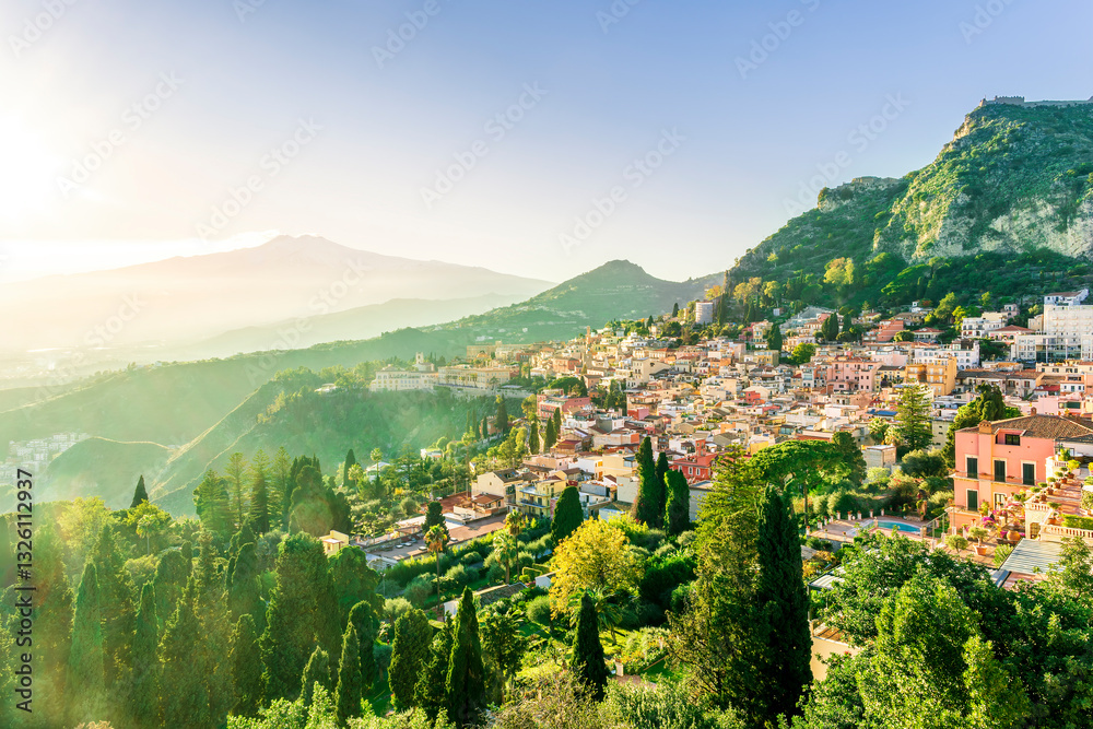 Fototapeta premium Taormina town, Sicily, Italy. View of Taormina town sunset landscape with mouintain evening beautiful sunset golden light