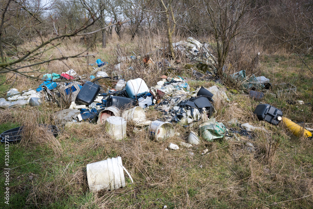 Illegal waste dump in the forest. Ecological disaster. Human stupidity, pollution of our own environment, the planet.
