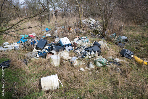 Obraz na płótnie Illegal waste dump in the forest. Ecological disaster. Human stupidity, pollution of our own environment, the planet.
w salonie