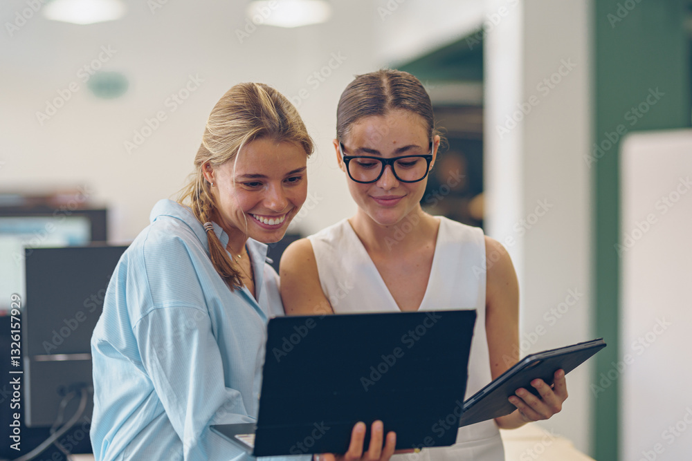 Women Engaging and Collaborating with Laptops in a Modern Office Environment Setting Women Engaging and Collaborating with Laptops in a Modern Office Environment Setting