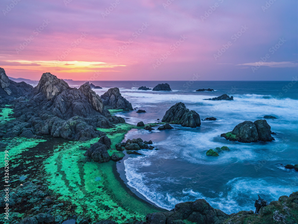 seascape at sunset with dramatic rock