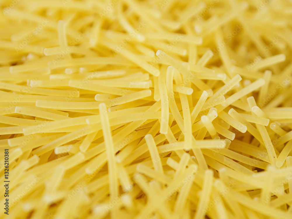 Close-up of small, thin vermicelli filini pasta. Delicate strands create a fine, textured food background. Close-up of small, thin vermicelli filini pasta. Delicate strands create a fine, textured food background.