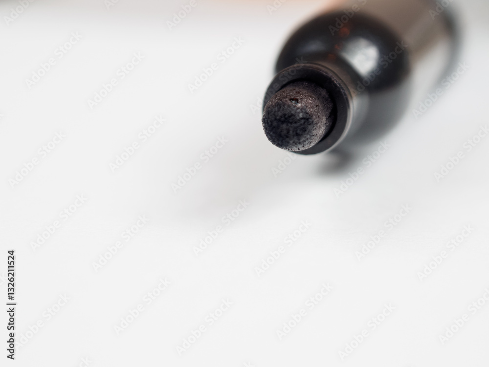image of a marker positioned on a blank sheet of paper, with ample free space in the background. image of a marker positioned on a blank sheet of paper, with ample free space in the background.