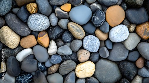 A background of polished pebbles in various shades of gray, stones on the beach