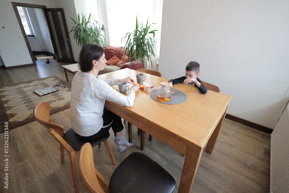 Mother and a boy spending time together playing indoors Mother and a boy spending time together playing indoors