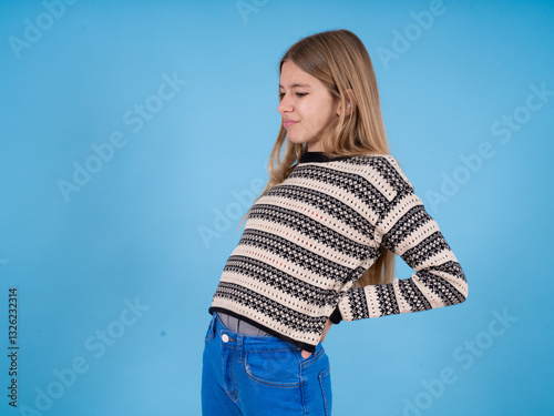 beautiful caucasian girl wearing striped sweater got back pain