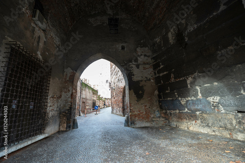 Pathway in Castelvecchio with pointed archway towards the Castelvecchio bridge in Verona, Italy 