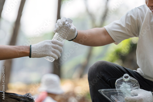 Collaborative Cleanup. Volunteers exchanging waste during a park cleanup.