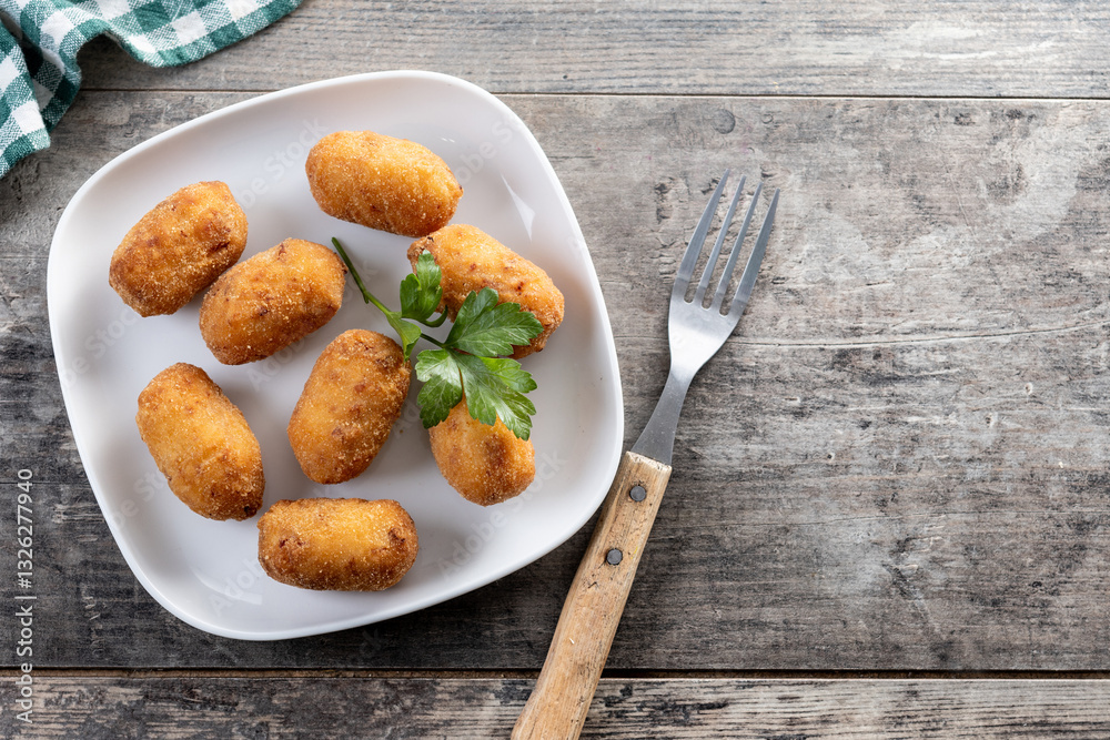 Fried cod croquettes on wooden table. Top view. Copy space Fried cod croquettes on wooden table. Top view. Copy space
