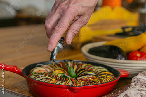 Wallpaper Mural Chef preparing traditional Provençal vegetable dish Ratatouille with stuffed rolled meat on the grill. French food. Healthy eating. Delicious vegetable Torontodigital.ca