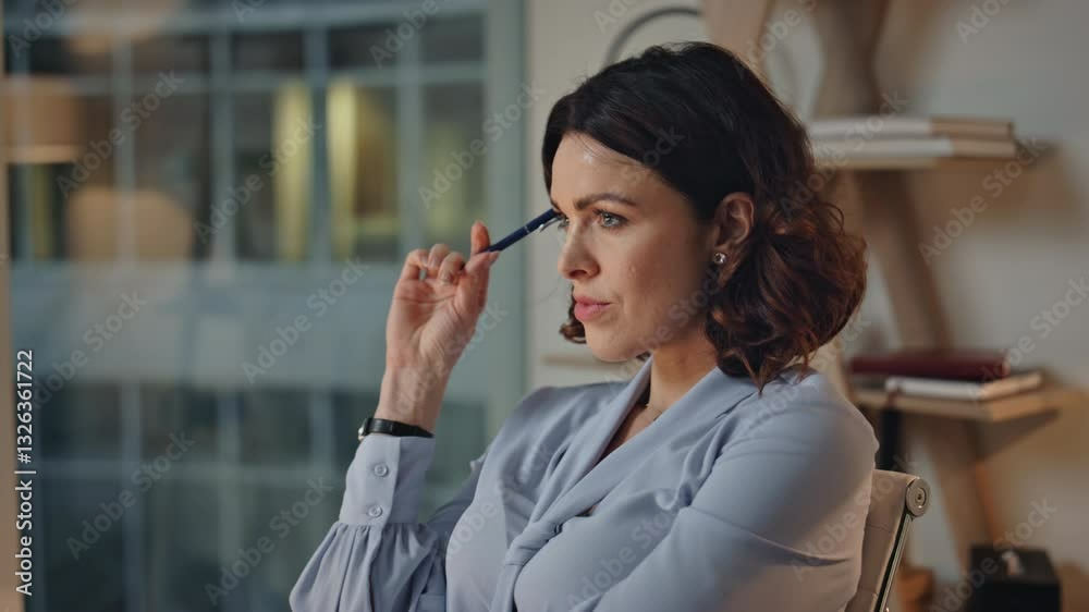 Thoughtful woman holding pen pondering ideas at evening workplace closeup. Thoughtful woman holding pen pondering ideas at evening workplace closeup.