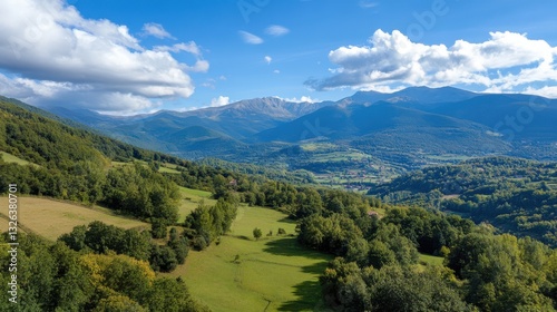 Scenic Mountain Valley Landscape with Meadows and Cloudy Sky