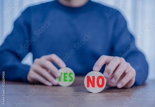 Yes or No decision idea. Checklist option communication, A man showing  message yes noin icon on front wood, is future decisionof him to decide on your own path. making decision, True False