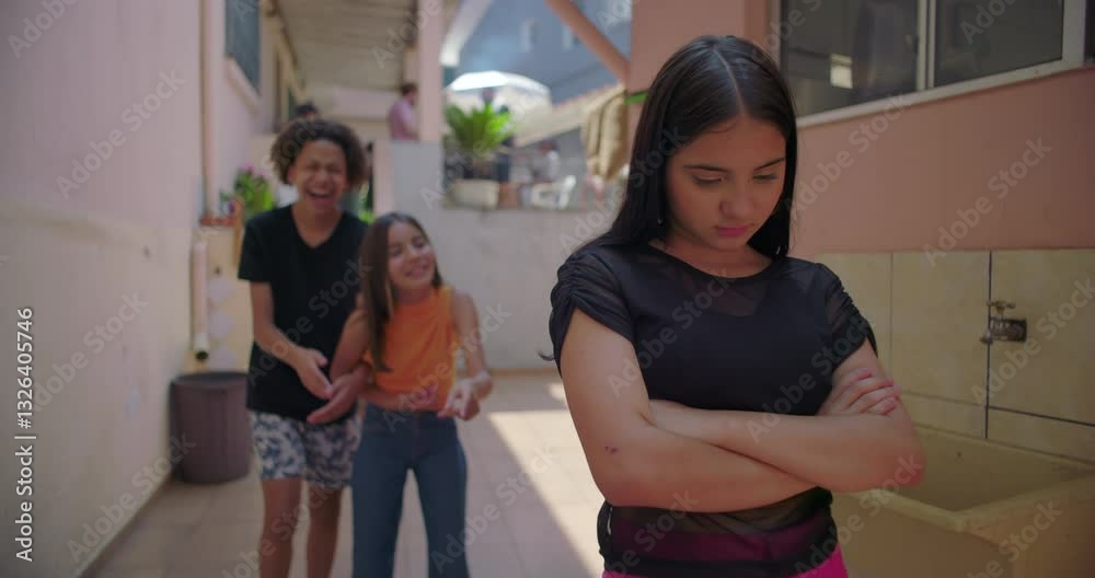 Teenager feeling isolated and upset as friends mock her in suburban alleyway, representing themes of bullying, peer pressure, and social dynamics in youth culture