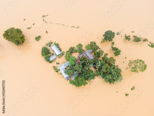 Aerial view of flooded village with submerged houses and trees, Jhenaigati, Sherpur, Bangladesh. photo