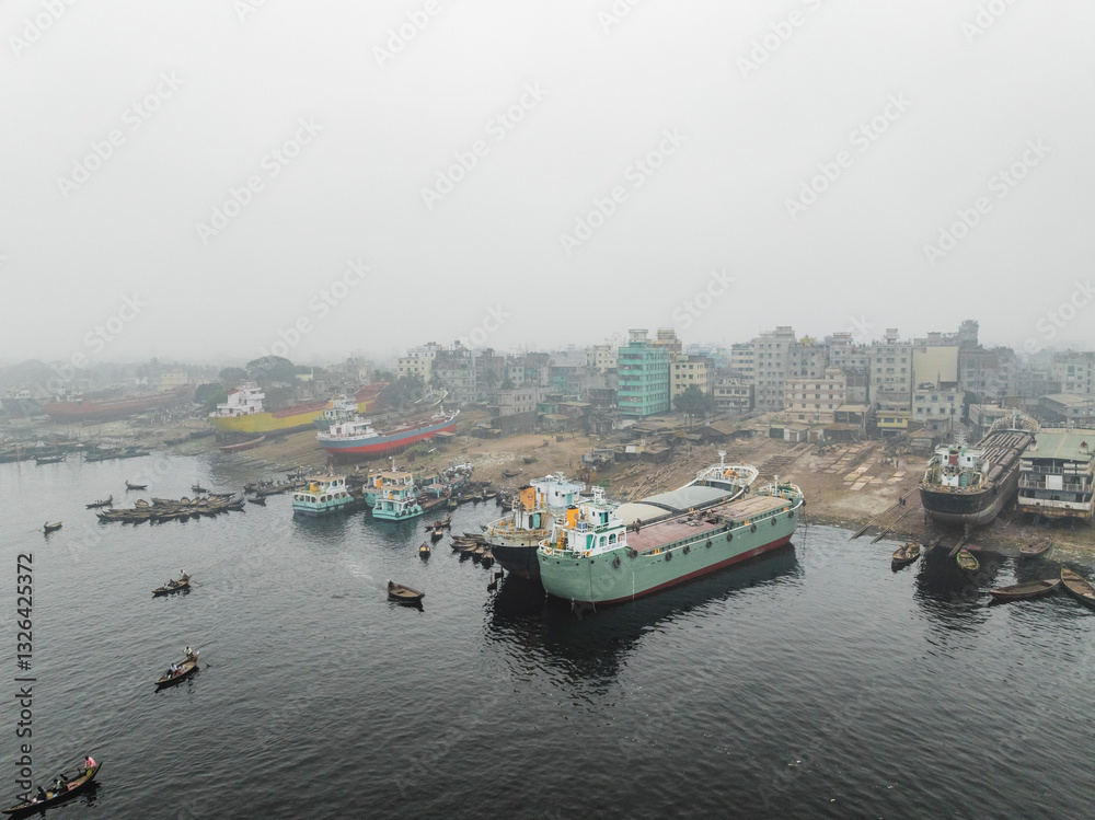 Aerial view of shipyard along Buriganga river with modern buildings and vessels, Subhadya, Keraniganj, Dhaka, Bangladesh. Aerial view of shipyard along Buriganga river with modern buildings and vessels, Subhadya, Keraniganj, Dhaka, Bangladesh.