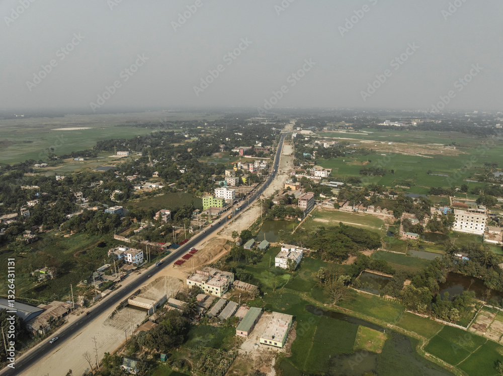 Aerial view of a peaceful rural village with greenery, fields, and roads, Satgram, Araihazar, Dhaka, Bangladesh. Aerial view of a peaceful rural village with greenery, fields, and roads, Satgram, Araihazar, Dhaka, Bangladesh.