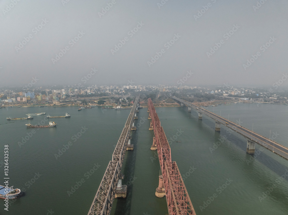 Aerial view of the beautiful Meghna River with a prominent bridge and bustling cityscape, Bhairab, Dhaka, Bangladesh. Aerial view of the beautiful Meghna River with a prominent bridge and bustling cityscape, Bhairab, Dhaka, Bangladesh.