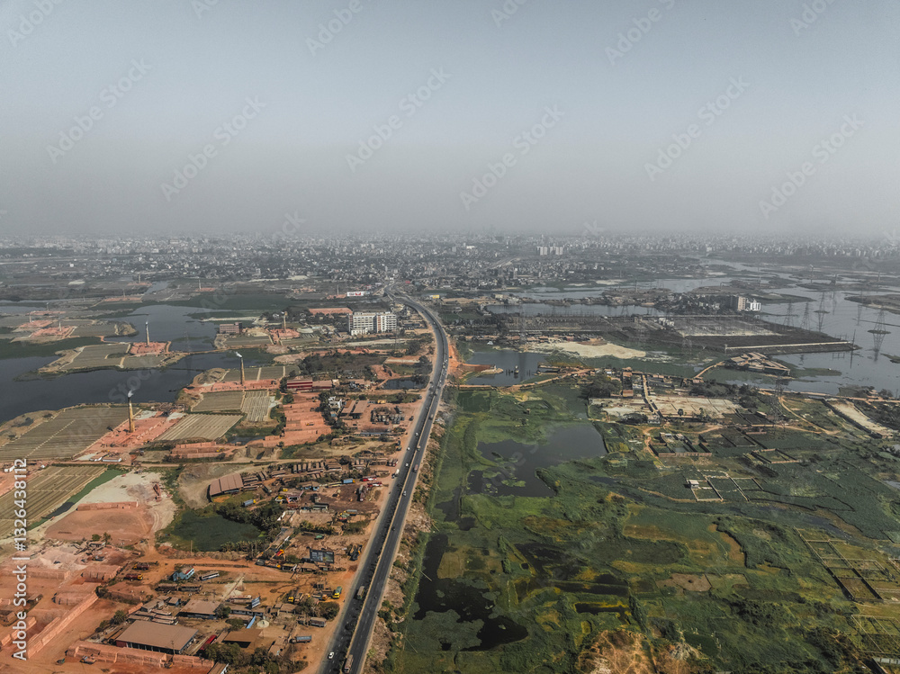 Aerial view of industrial brick fields and factory amidst urban development and wetlands, Tetuljhora, Savar, Dhaka, Bangladesh. Aerial view of industrial brick fields and factory amidst urban development and wetlands, Tetuljhora, Savar, Dhaka, Bangladesh.