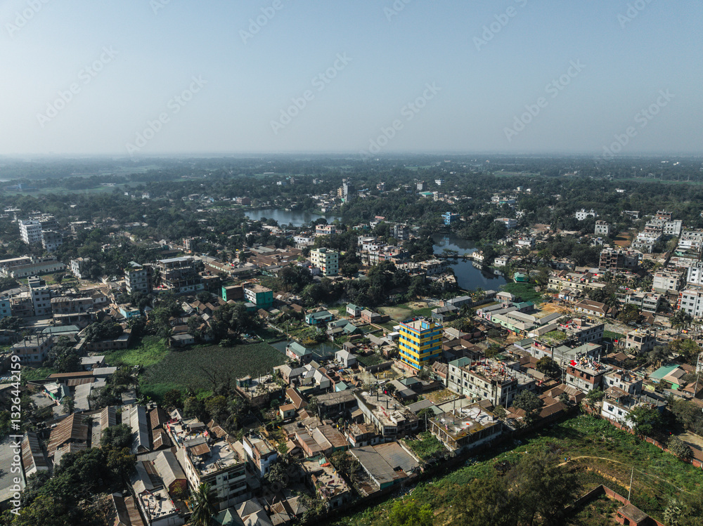 Aerial view of a vibrant cityscape with residential buildings and lush greenery near a river, Pathalia, Savar, Dhaka, Bangladesh. Aerial view of a vibrant cityscape with residential buildings and lush greenery near a river, Pathalia, Savar, Dhaka, Bangladesh.