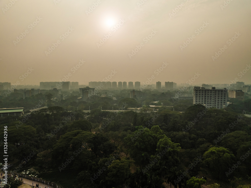 Aerial view of hazy cityscape with modern buildings and greenery in park, Shahbag, Dhaka, Bangladesh. Aerial view of hazy cityscape with modern buildings and greenery in park, Shahbag, Dhaka, Bangladesh.