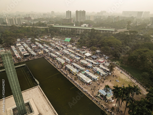 Aerial view of bustling book fair with vibrant pavilions and crowd in urban park, Shahbag, Dhaka, Bangladesh. photo