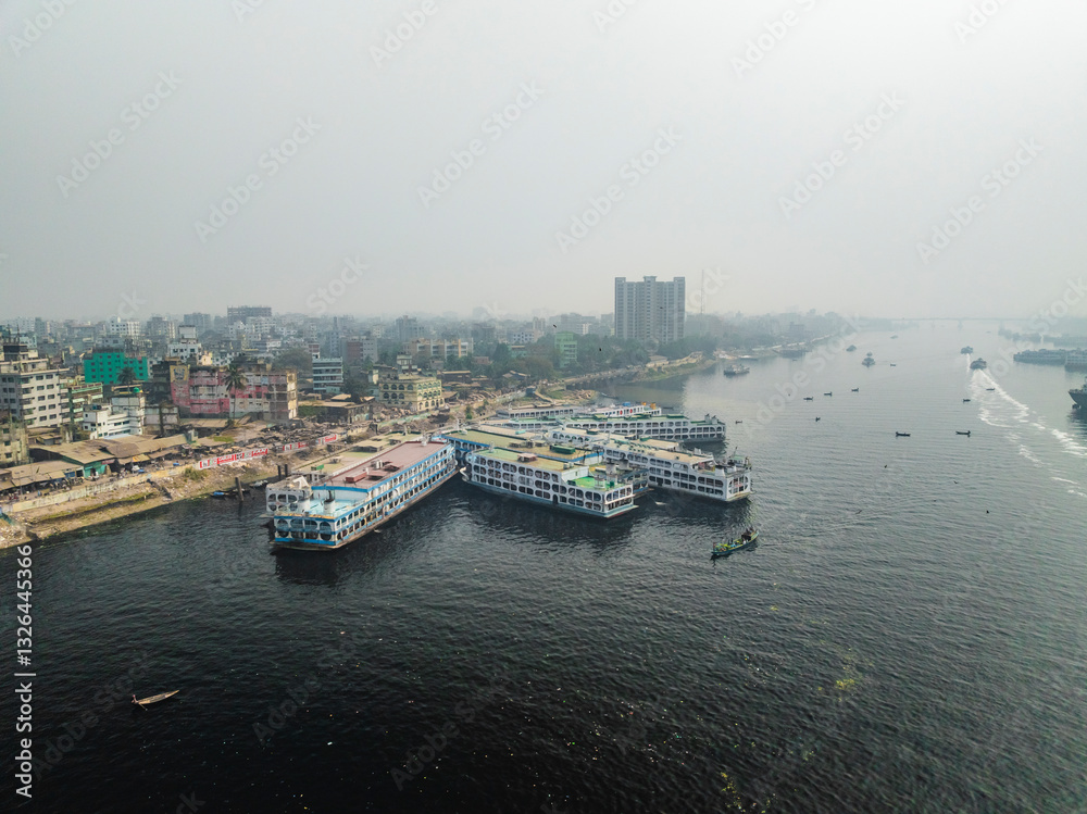 Aerial view of buriganga river with boats and cityscape in Keraniganj, Dhaka, Bangladesh. Aerial view of buriganga river with boats and cityscape in Keraniganj, Dhaka, Bangladesh.