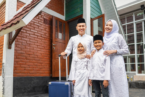 Photos An Indonesian Muslim family with a suitcase arrives in their hometown