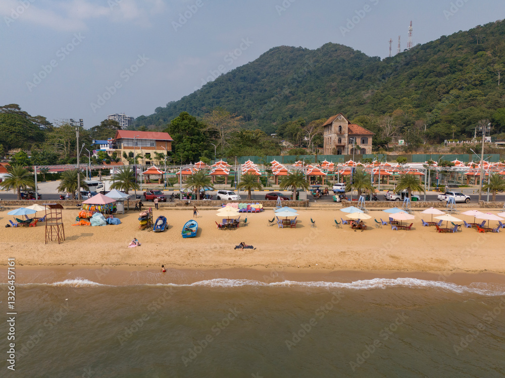 Aerial view of kep beach with tropical umbrellas and calm water, Prey Thum, Kaeb, Cambodia. Aerial view of kep beach with tropical umbrellas and calm water, Prey Thum, Kaeb, Cambodia.