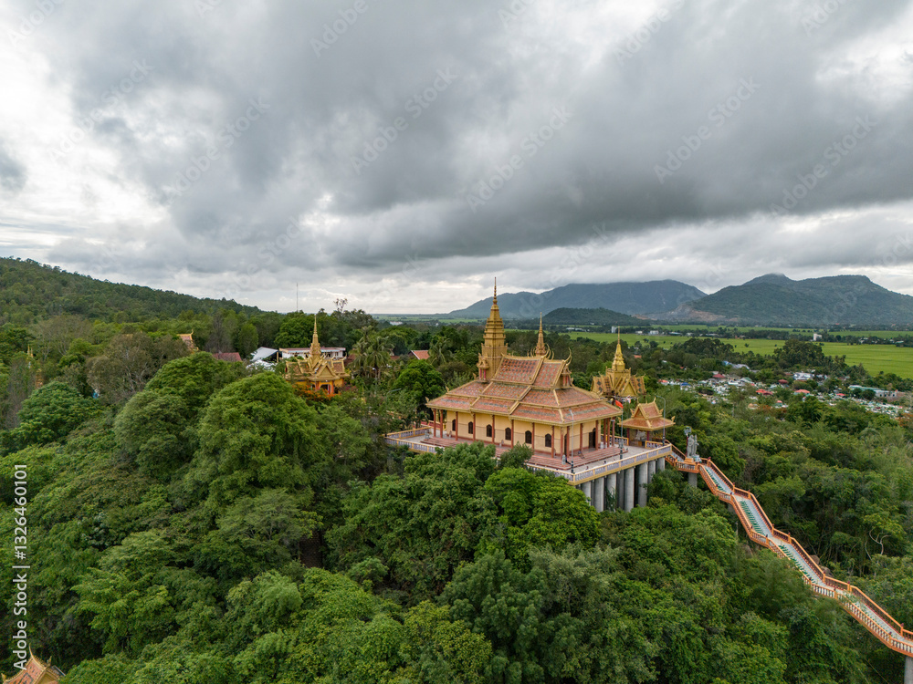 Aerial view of a scenic buddhist temple and pagoda surrounded by lush forest and mountains, Nui To, Tri Ton, An Giang, Vietnam. Aerial view of a scenic buddhist temple and pagoda surrounded by lush forest and mountains, Nui To, Tri Ton, An Giang, Vietnam.