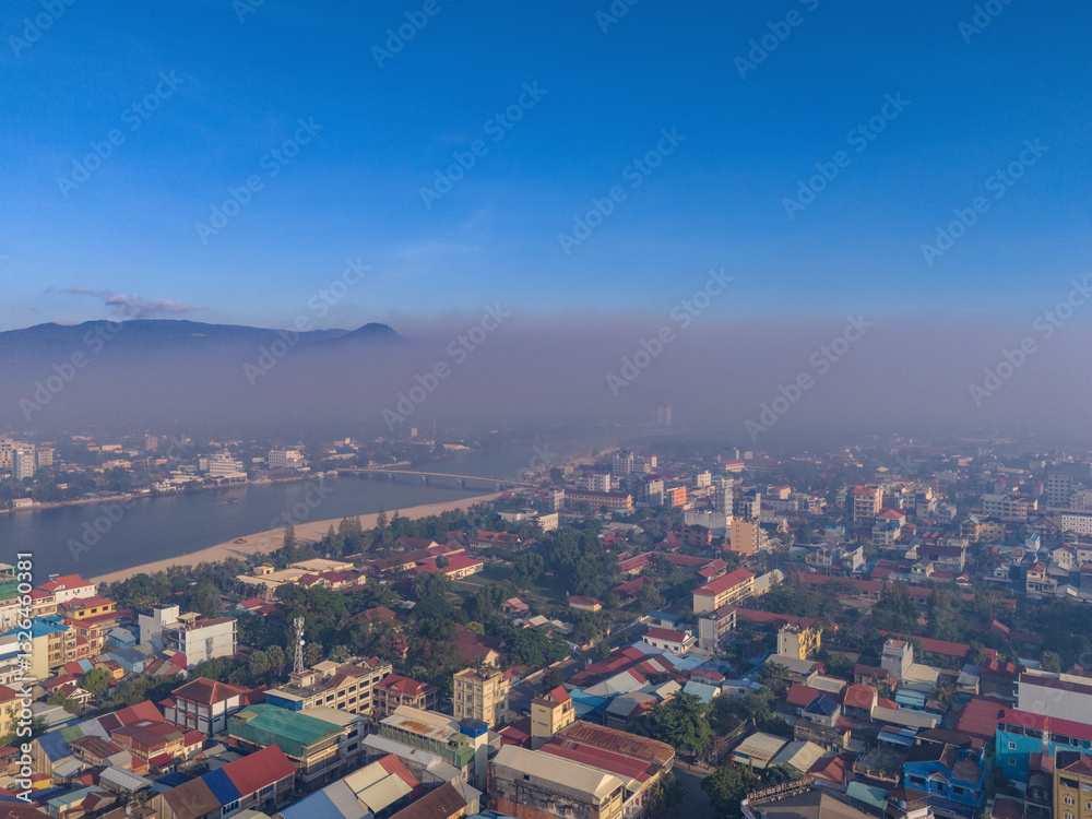Aerial view of cityscape with smoke from fire in the Bokor Mountain and river, Kampong Kandal, Kampot, Cambodia. Aerial view of cityscape with smoke from fire in the Bokor Mountain and river, Kampong Kandal, Kampot, Cambodia.