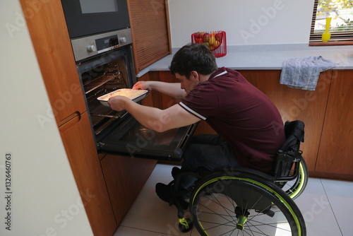 Man in wheelchair baking in kitchen photo